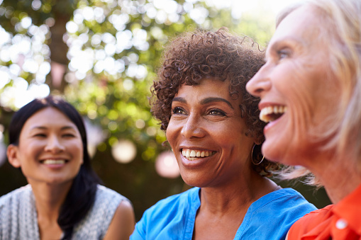 A group of smiling older women with dental implants from Glen Perio in Glenview, IL