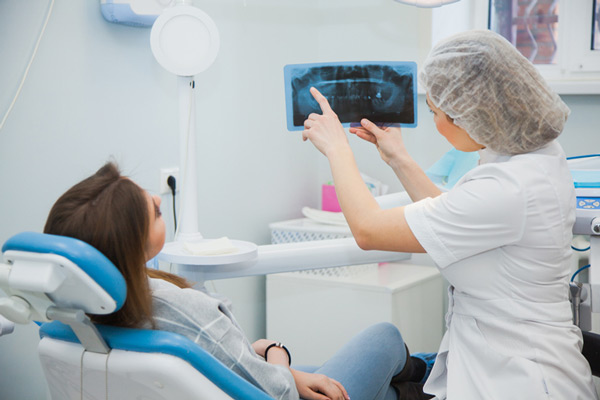 A woman reviewing her xray with a dentist after bone grafting at Glen Perio in Glenview, IL