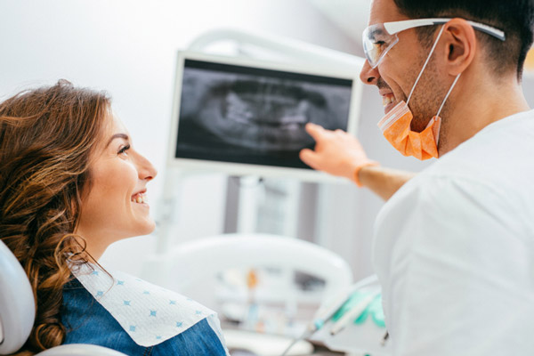 Dentist explaining an xray to a woman with a gum graft at Glen Perio in Glenview, IL